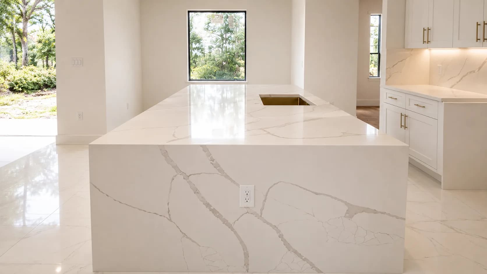 Waterfall quartz island in a bright, sunlit room
