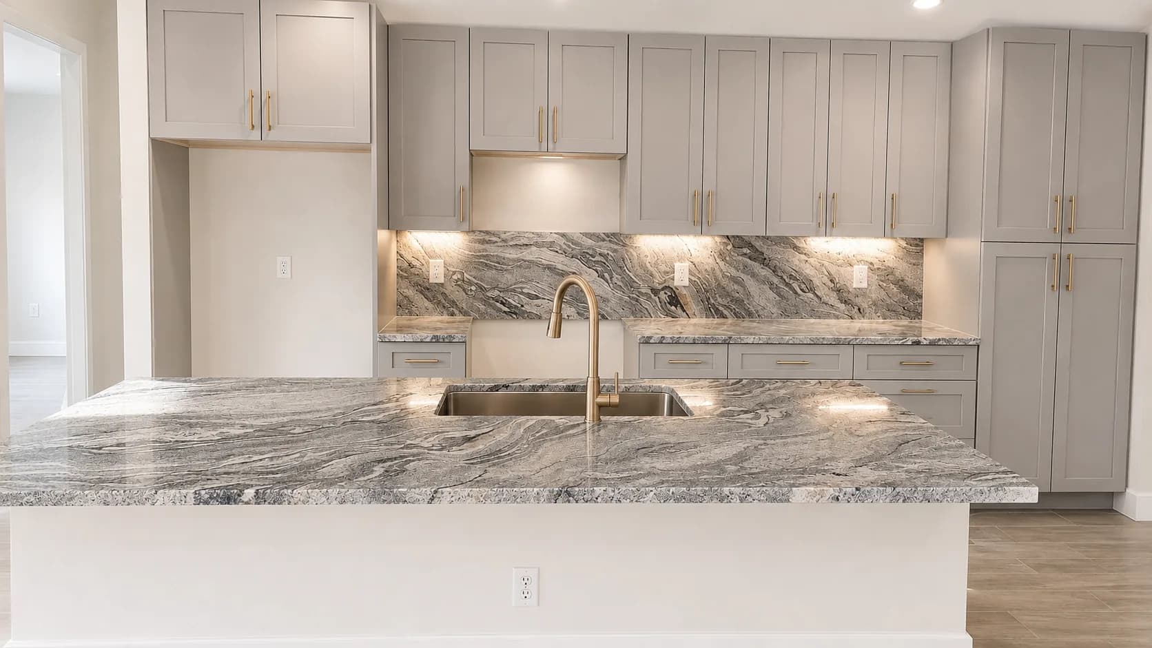 Natural stone waterfall island and matching backsplash