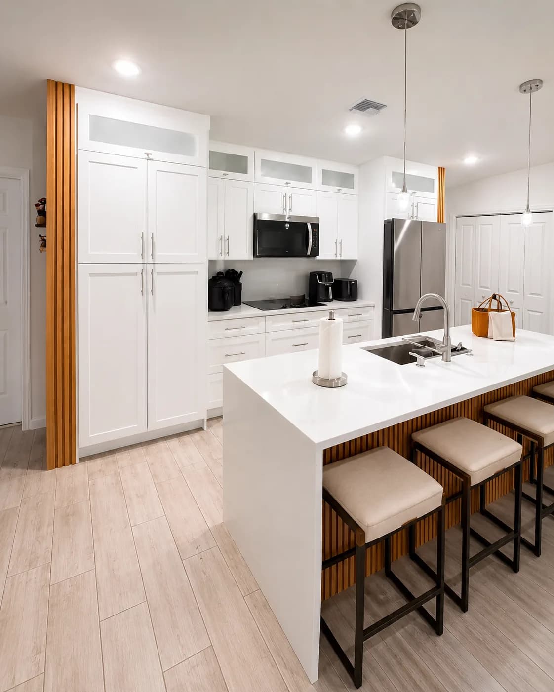 White shaker cabinetry with wood slat accent column